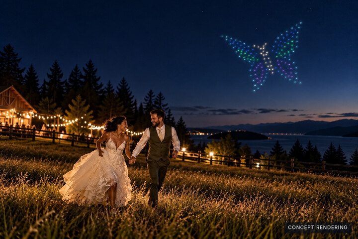 Concept: a couple celebrates beside an illuminated waterfront venue beneath a colourful butterfly formation.