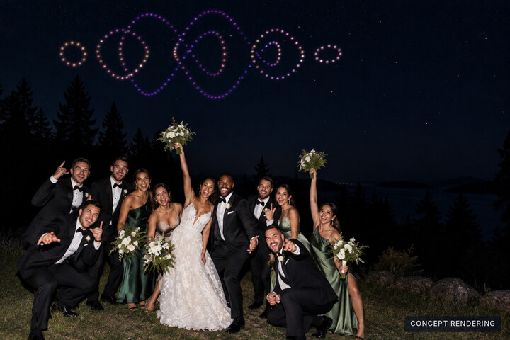 Concept: a wedding party celebrates together beneath a wide pink and violet formation.